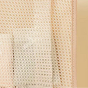 Beige mesh pouch with a beige border on a light beige background